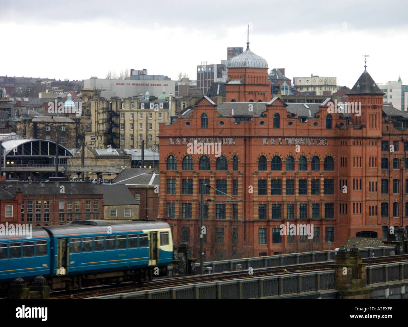 Train passing the Turnbull building in Newcastle upon Tyne Stock Photo