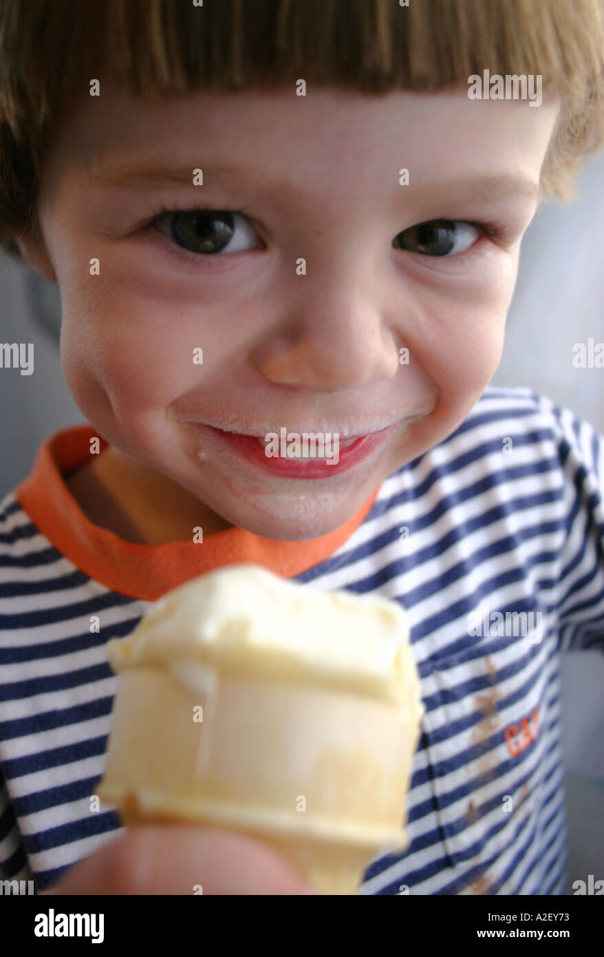 two year old child eating ice cream cone Stock Photo Alamy