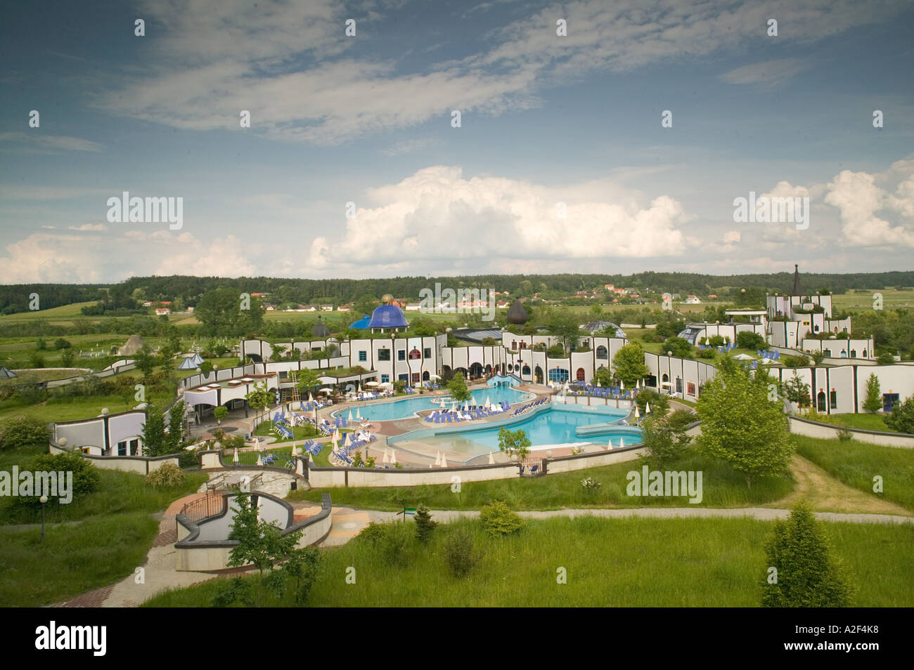 Austria, Styria, Stiermark. Rogner, Bad Blumau Hotel (b.1997) by Friedens Reich Hundertwasser, Pool View Stock Photo