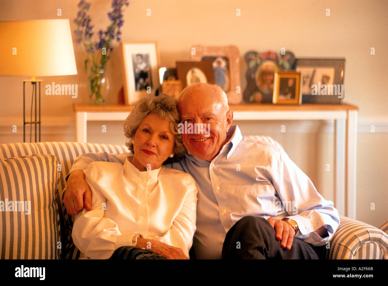 MATURE COUPLE SITTING ON SOFA Stock Photo