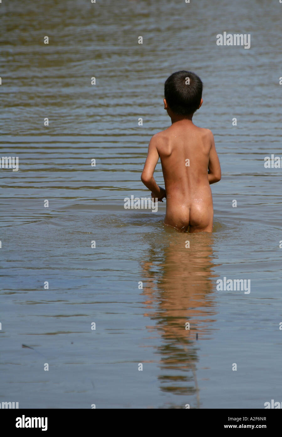 Naked Cambodian boy going to swim in Tonle Sap Lake in the Angkor Area,  Cambodia Stock Photo - Alamy