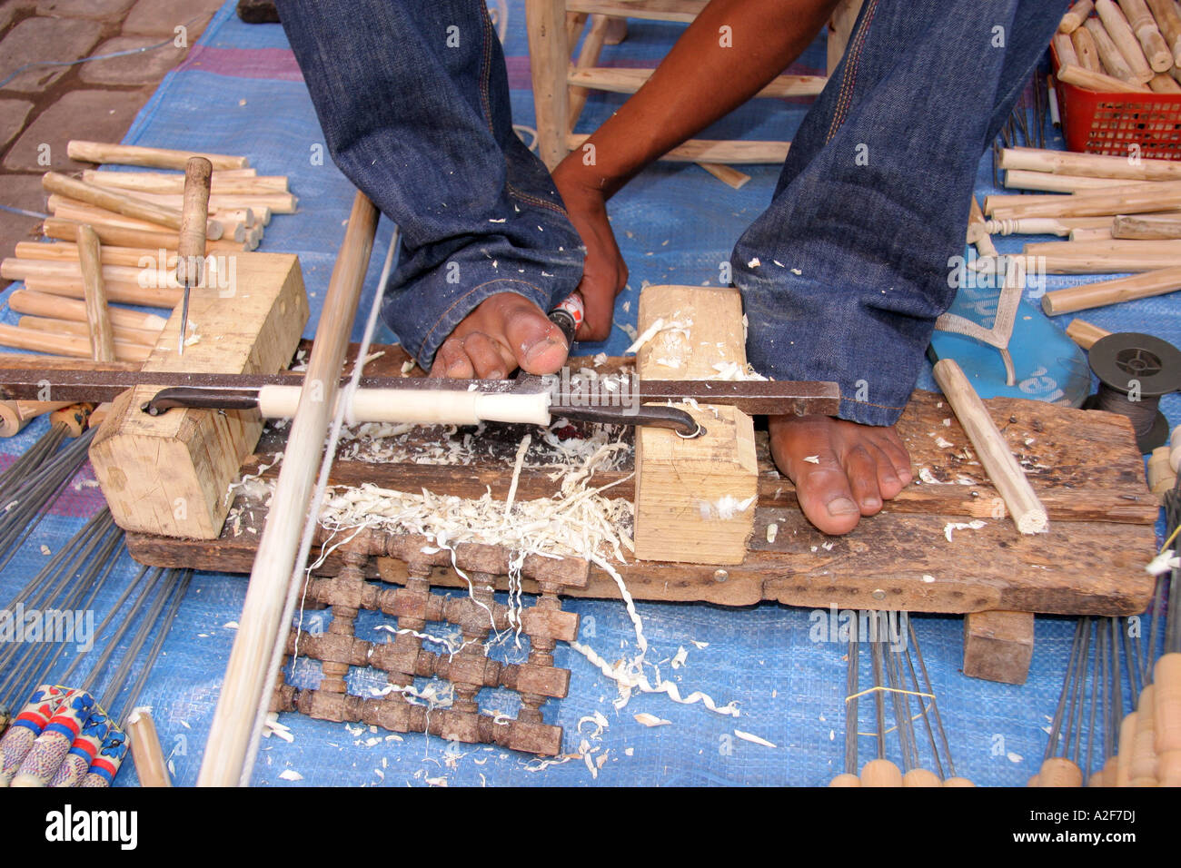 Detail of primitive lathe making handles for kebab skewers using toes