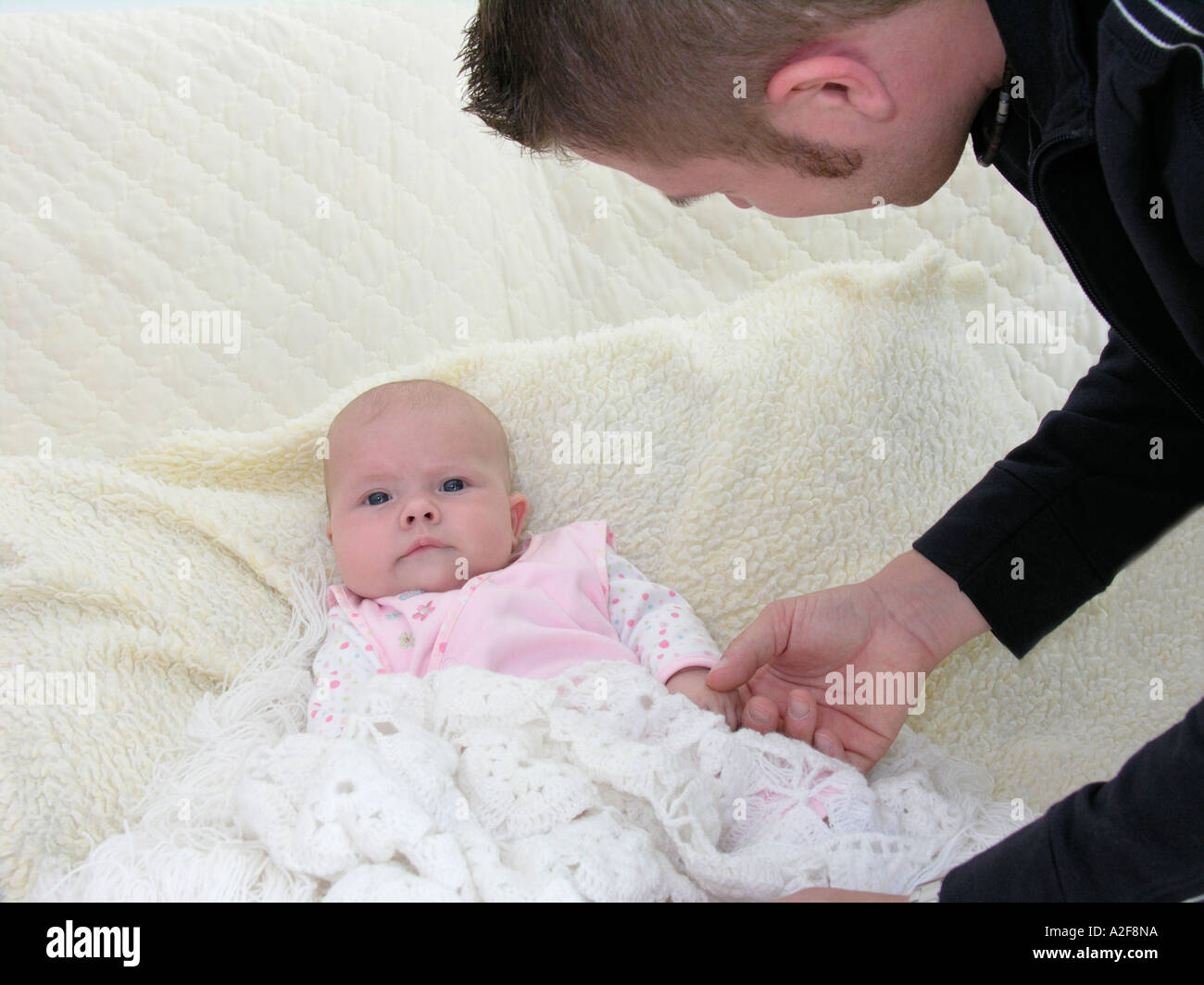 proud father fussing his baby daughter Stock Photo