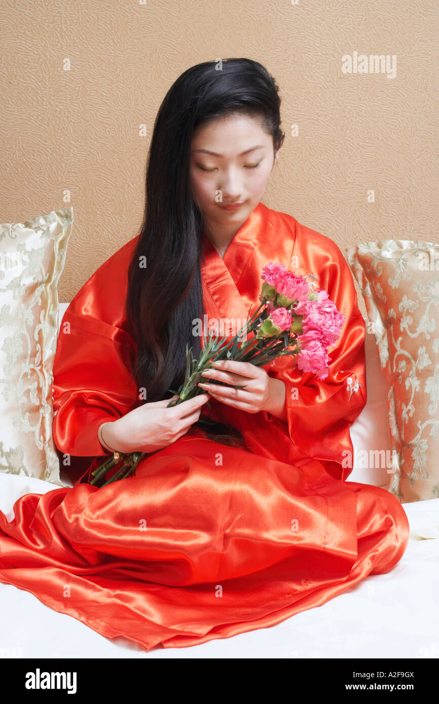 Young woman holding a bunch of flowers Stock Photo