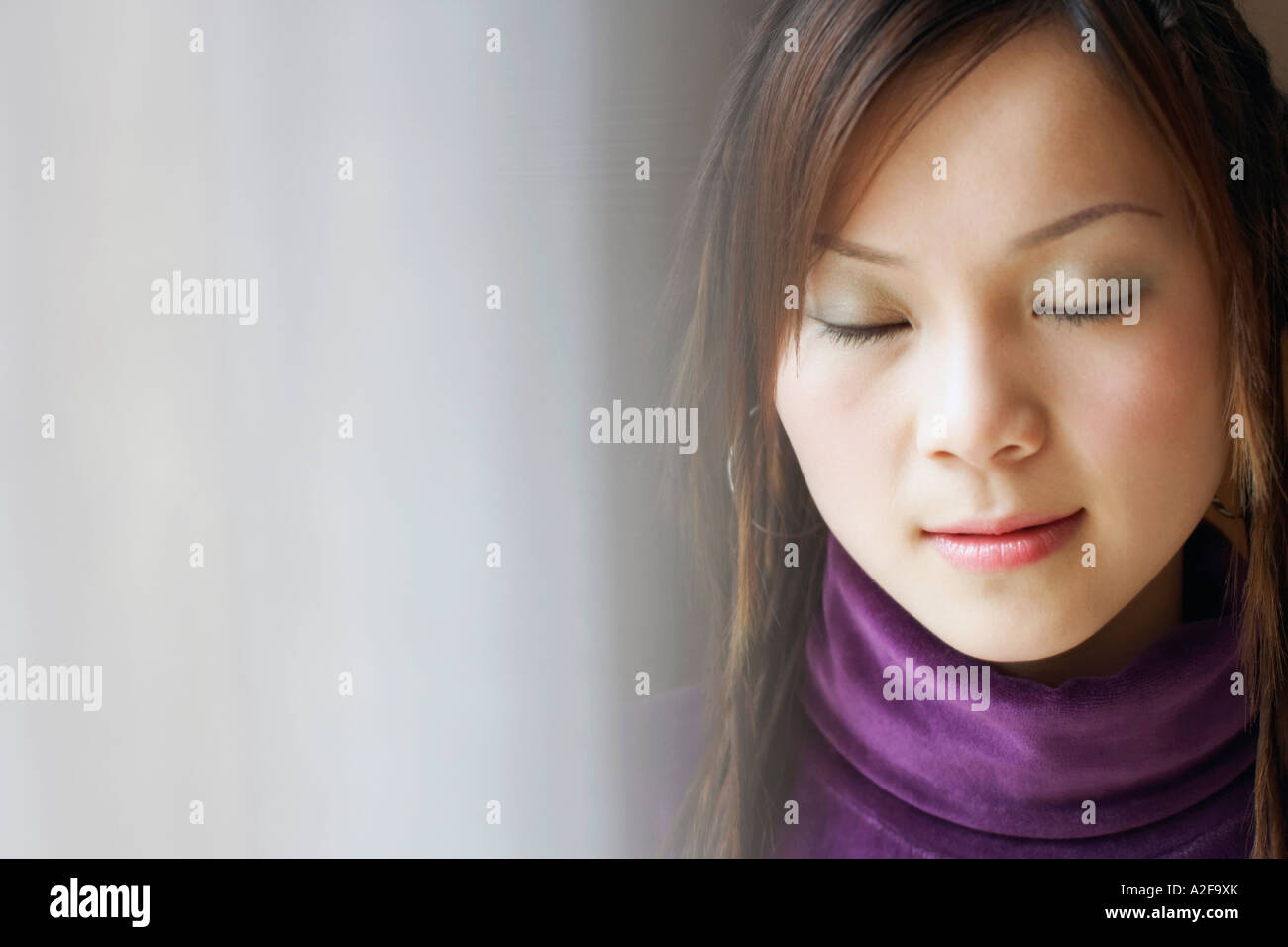 Close-up of a young woman with her eyes closed Stock Photo - Alamy