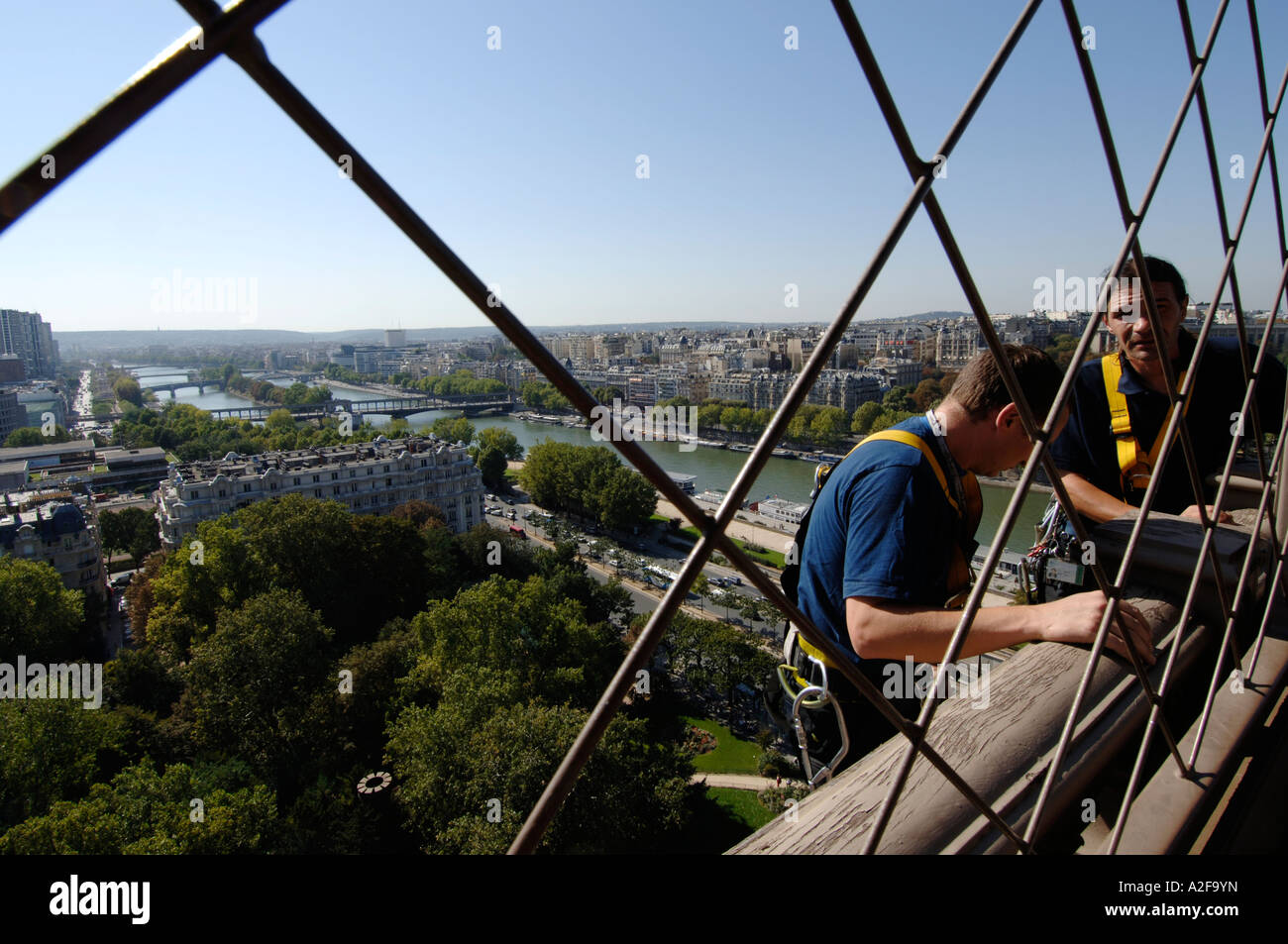 Paris, Eiffel Tower, Tour Eiffel, river Seine, worker on outside of the first floor platform Stock Photo