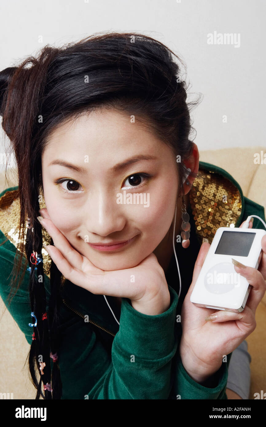 Portrait of a young woman listening to music Stock Photo - Alamy