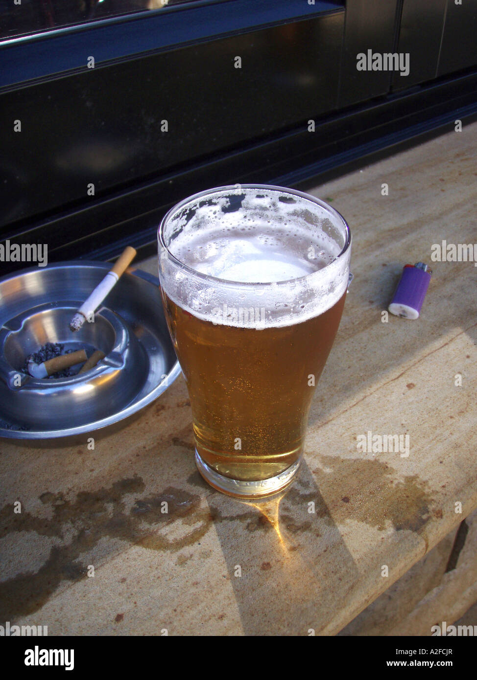 A beer and a cigarette Stock Photo Alamy