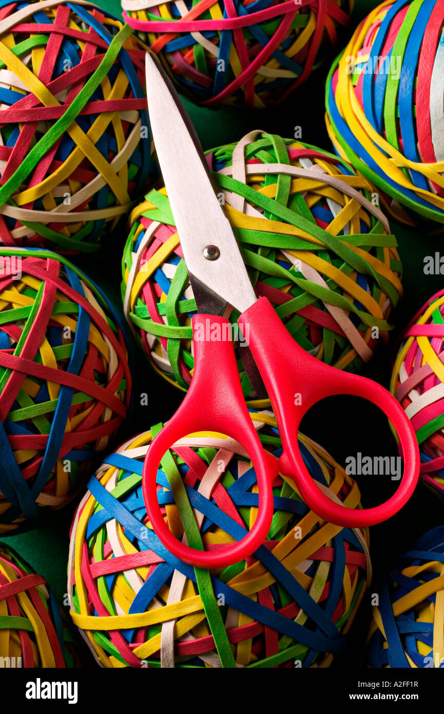 Scissors on top of rubberband balls Stock Photo Alamy