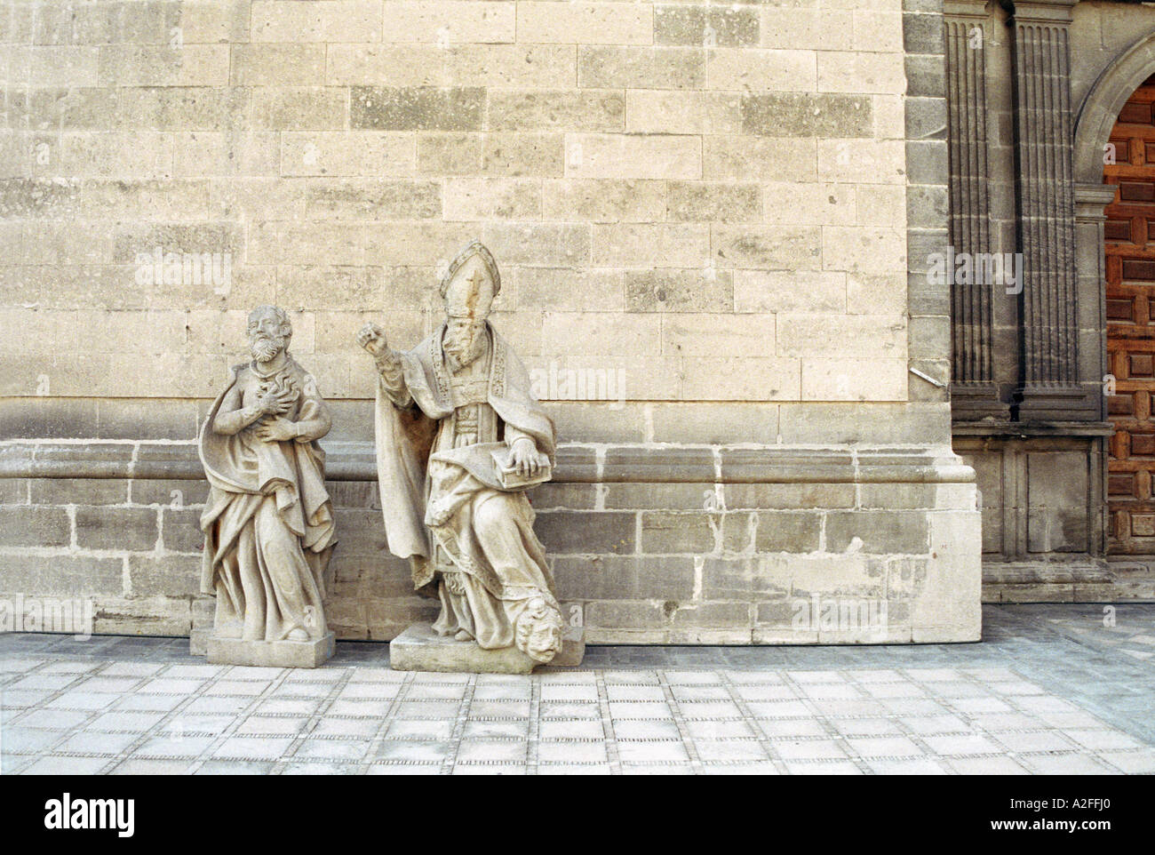 Two stone statues awaiting repairs in the courtyard of the cathedral in
