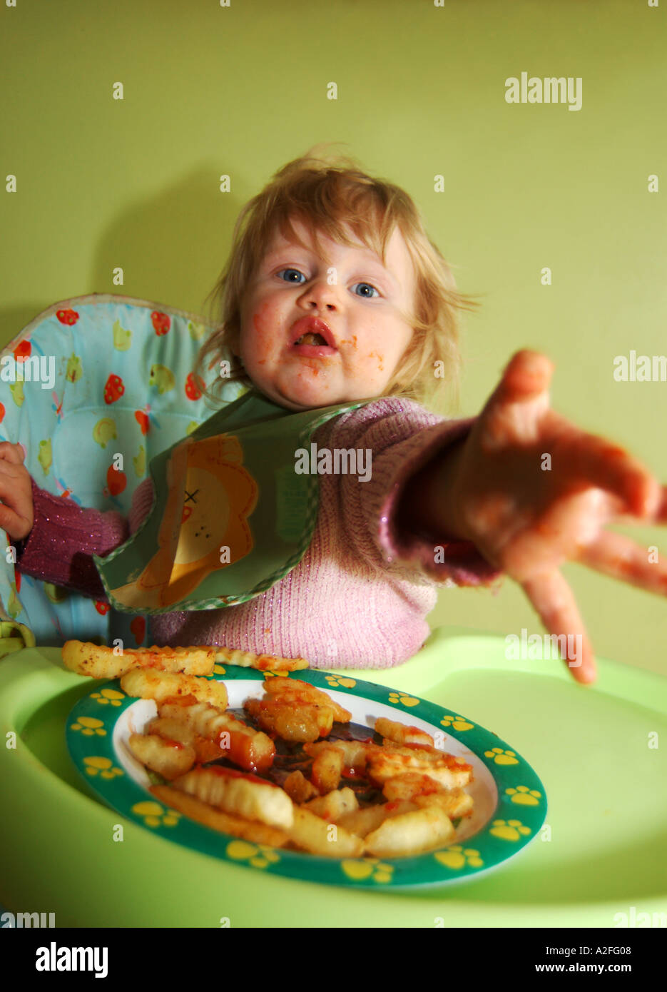 Female toddler eating chips UK Stock Photo Alamy