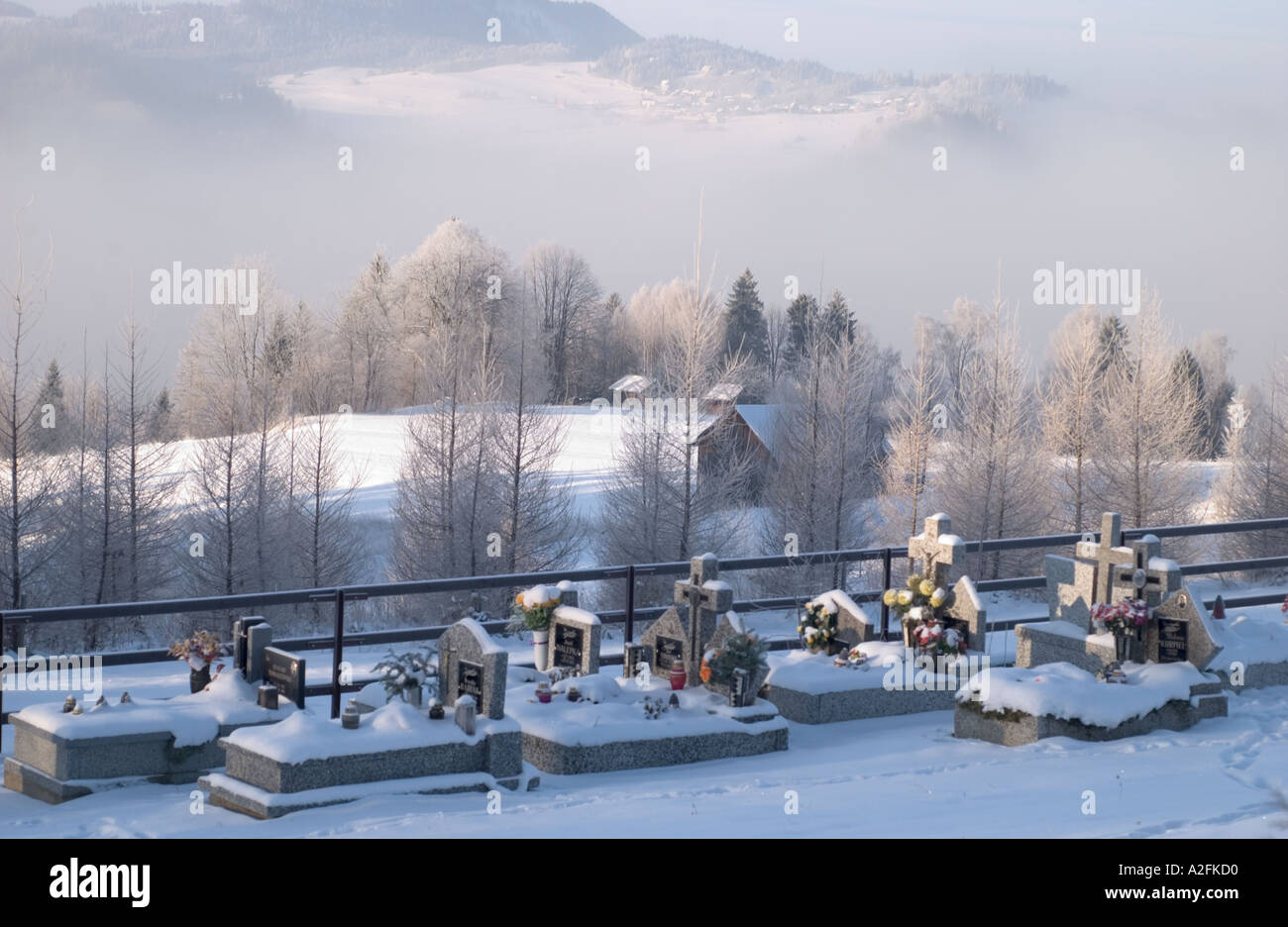 Czorsztyn, cemetery covered in snow, Tatra Mountains in the background, Poland, Europe, winter Stock Photo