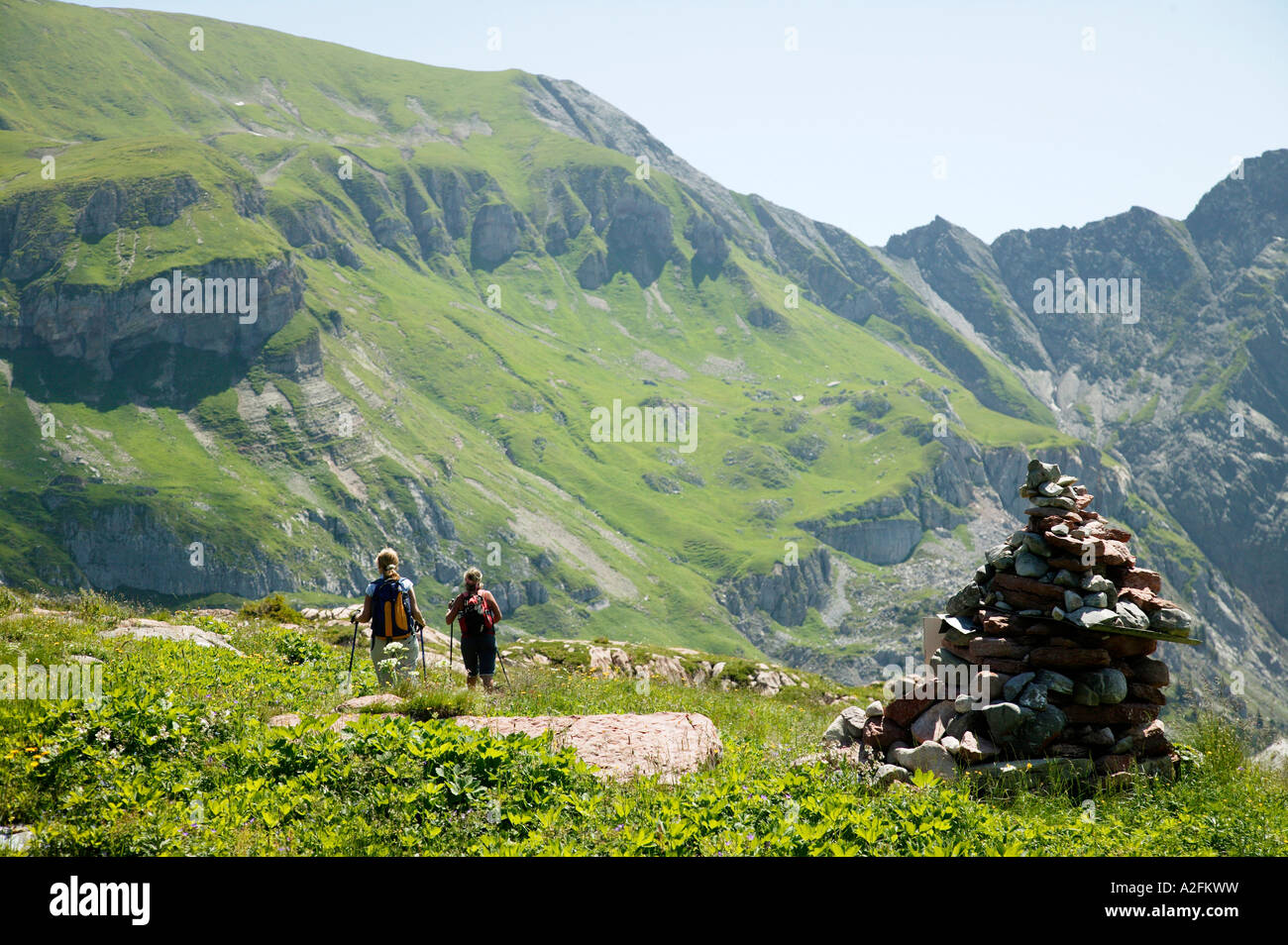Two people hiking in mountains Stock Photo - Alamy