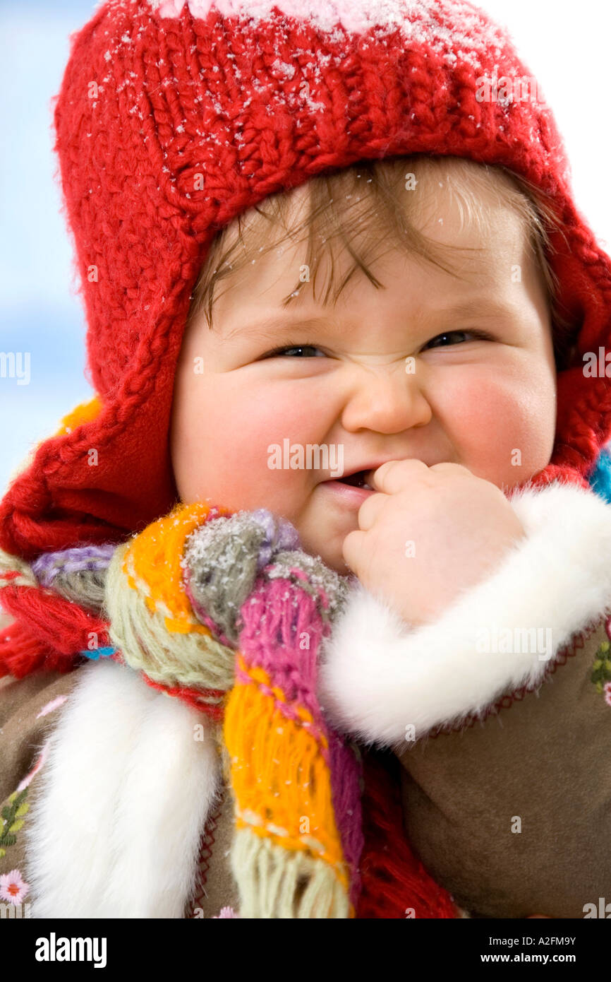 Baby girl (12-15 months) wearing cap, smiling, close-up Stock Photo