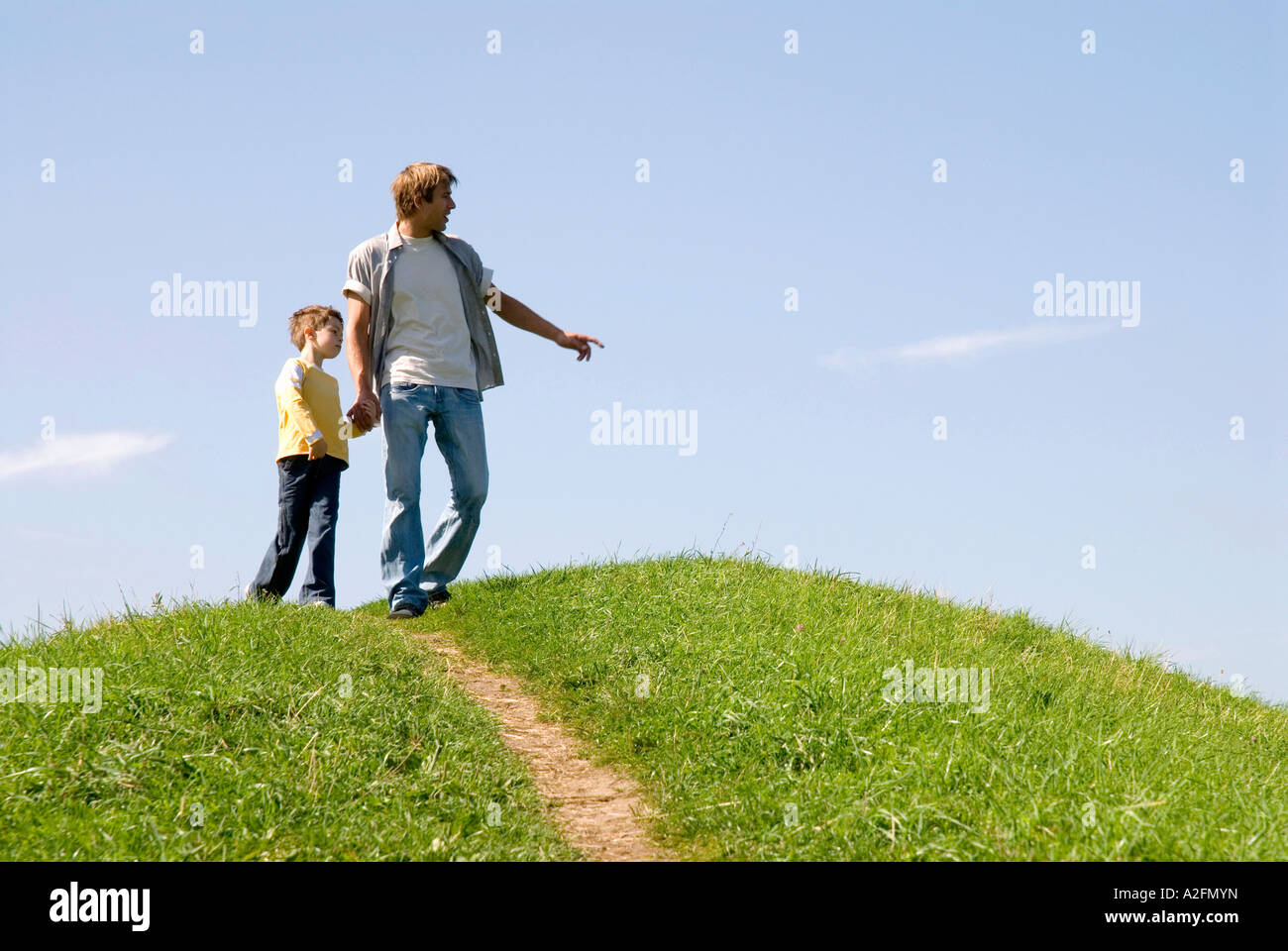 Father walking with son (4-7) hand in hand, low angle view Stock Photo