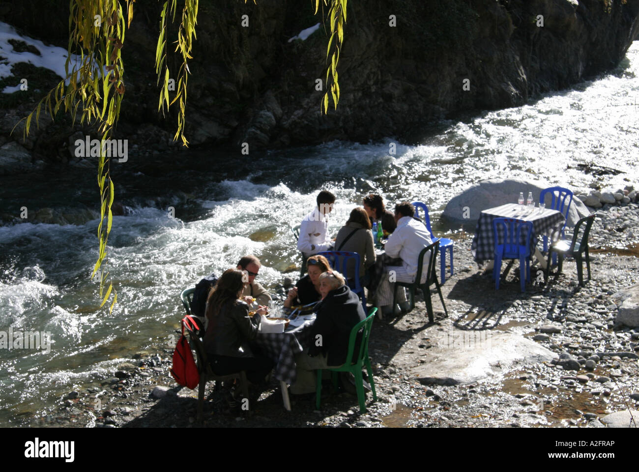 Tourists eating by the river in Morocco Stock Photo - Alamy