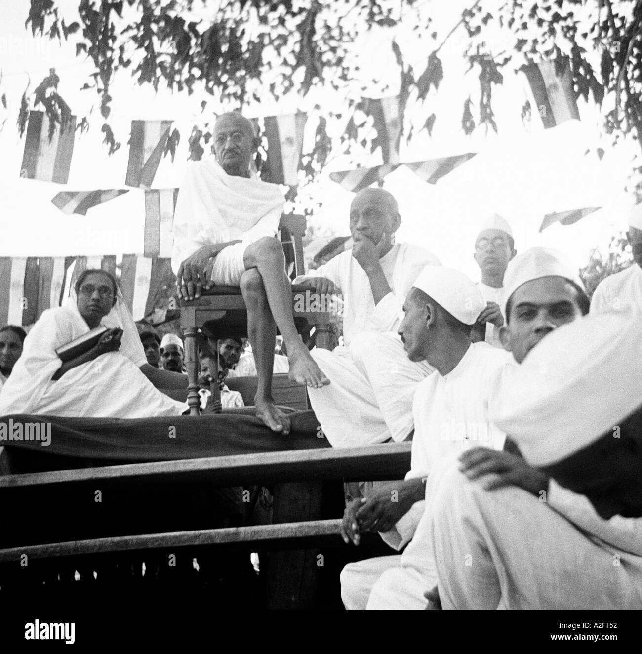 Mahatma Gandhi sitting with his co workers at an evening meeting in ...