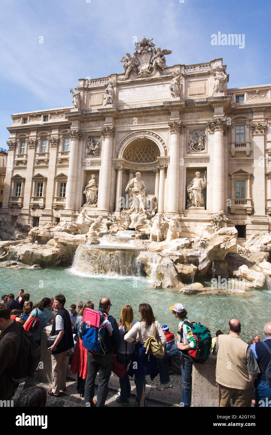 Trevi Fountain with tourists in summer sun sunshine and blue sky daylight daytime day Rome Italy Europe EU Stock Photo