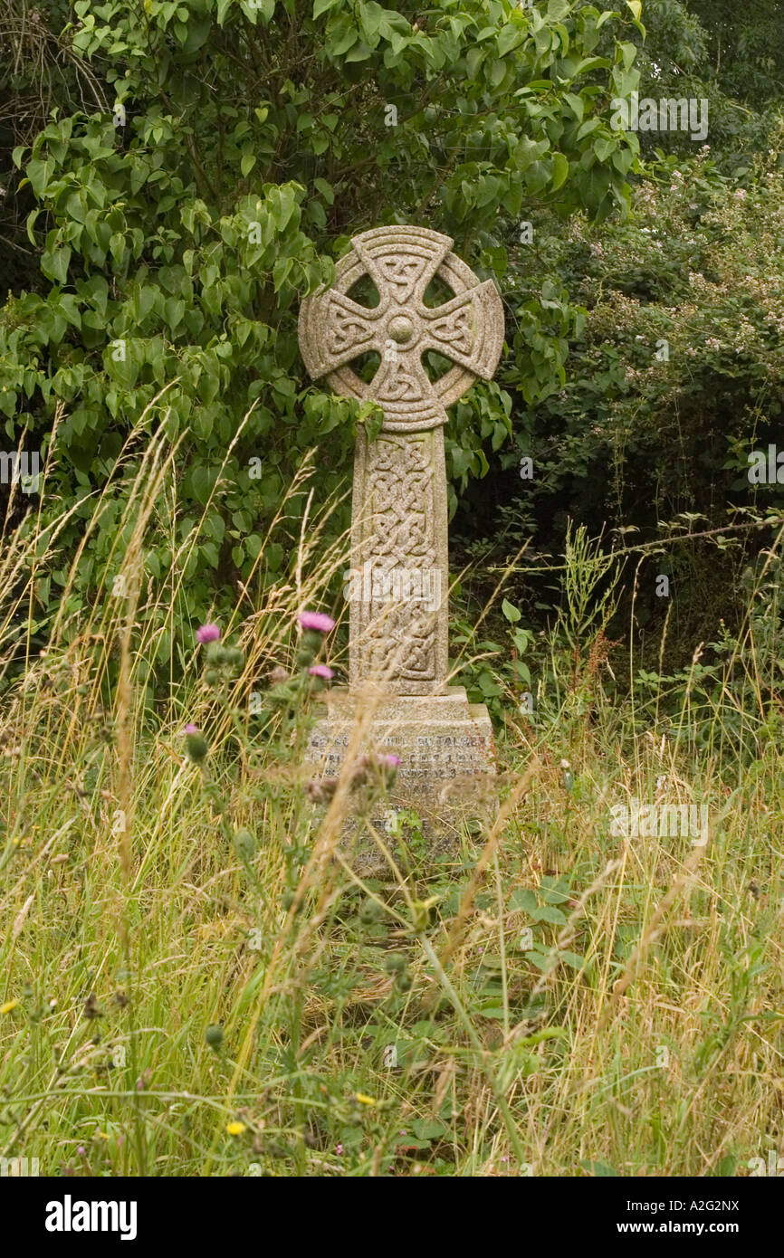 A cross with celtic knotwork carvings in the graveyard at Lacock Wiltshire England Stock Photo