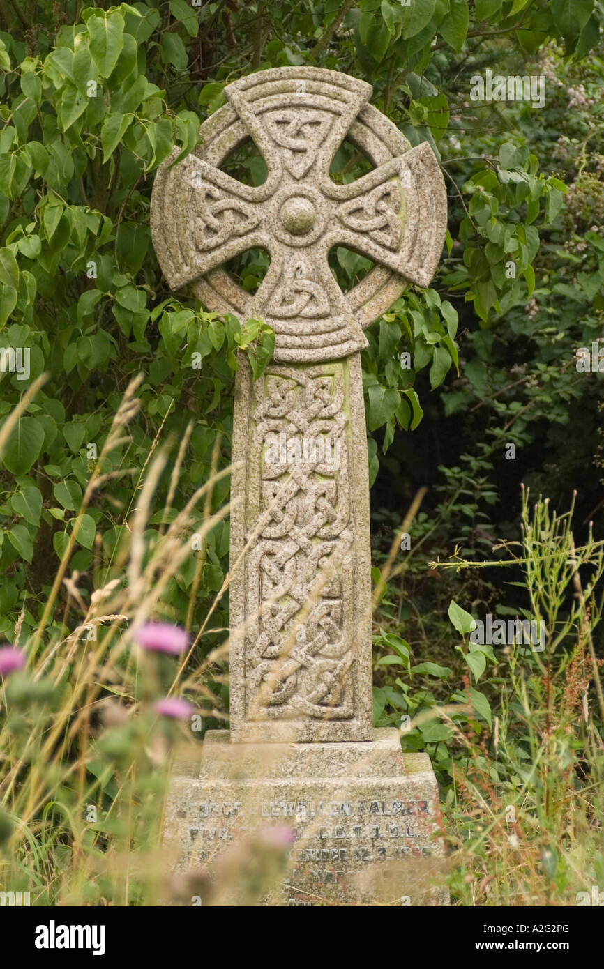 A cross with celtic knotwork carvings in the graveyard at Lacock Wiltshire England Stock Photo