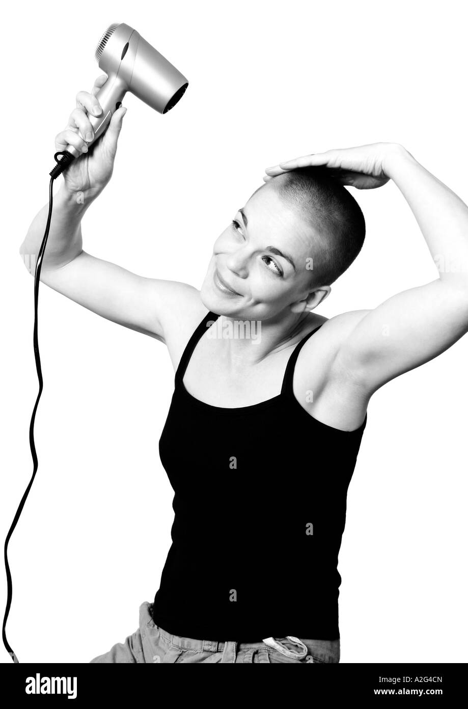 woman trying to style her cropped hair with dryer Stock Photo