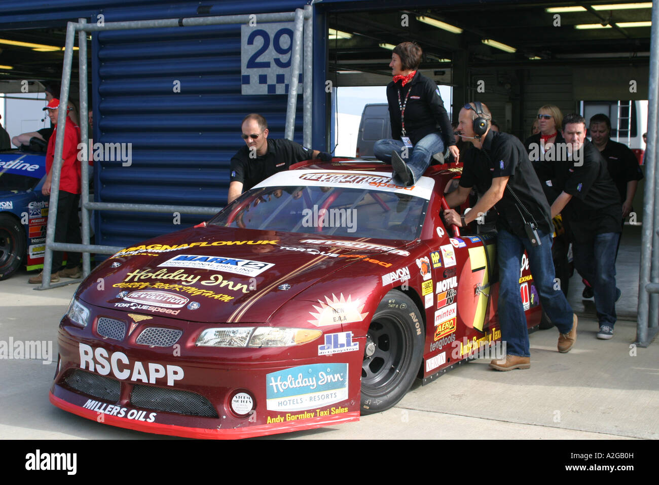 V8 Nascar Type Car Being Pushed Out Of Garage Stock Photo