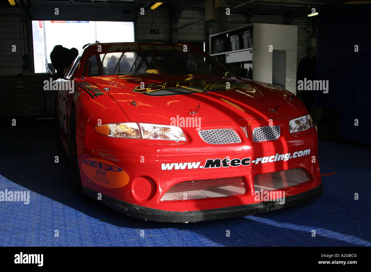 V8 Nascar Tyupe Stock Car In The Pit Lane Garage Stock Photo