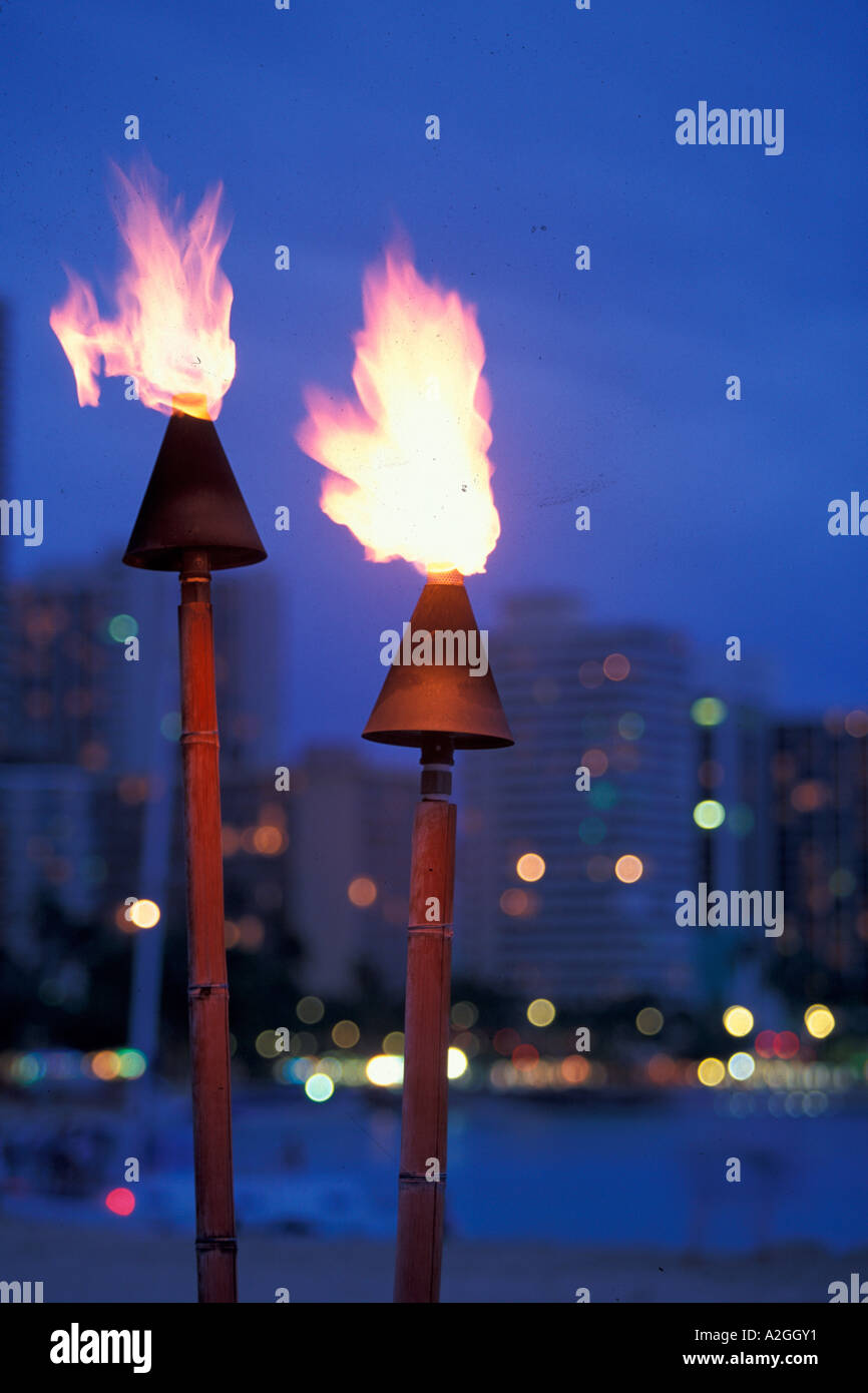 Hawaii Lit torches with skyline in background Stock Photo - Alamy