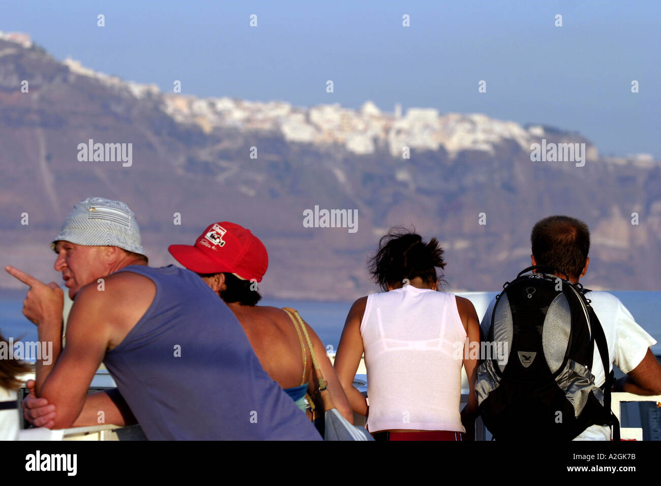 greece cyclades santorini tourists standing on deck of a ferry admiring ...