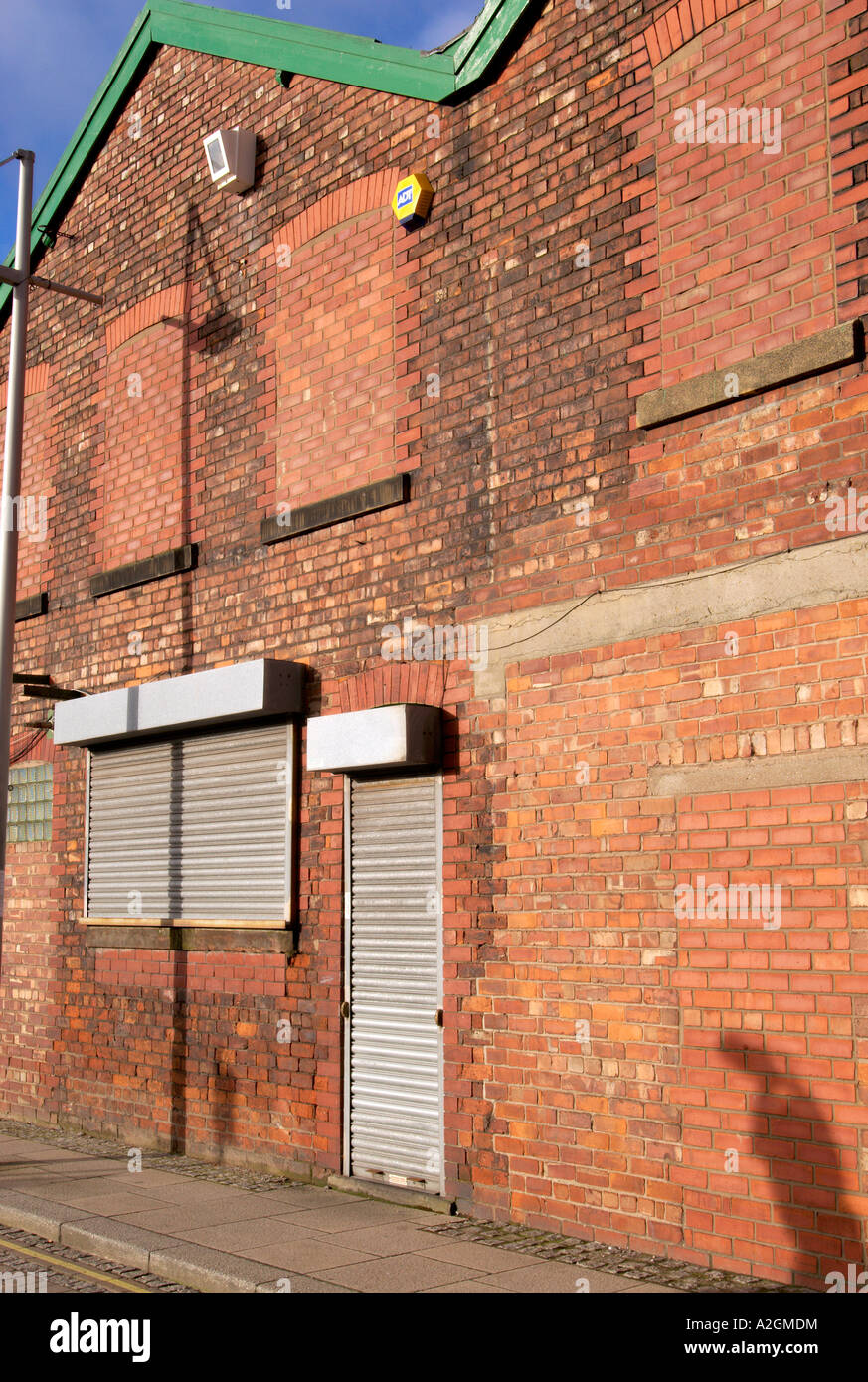 Building in the Ancoats area of East Manchester with windows bricked up for security Stock Photo