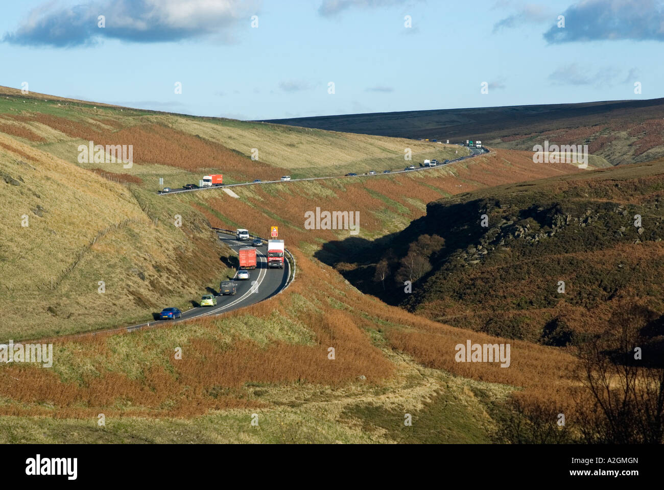 Traffic on the A628 route crossing the Woodhead Pass in the Longdendale Valley Derbyshire Yorkshire border Stock Photo