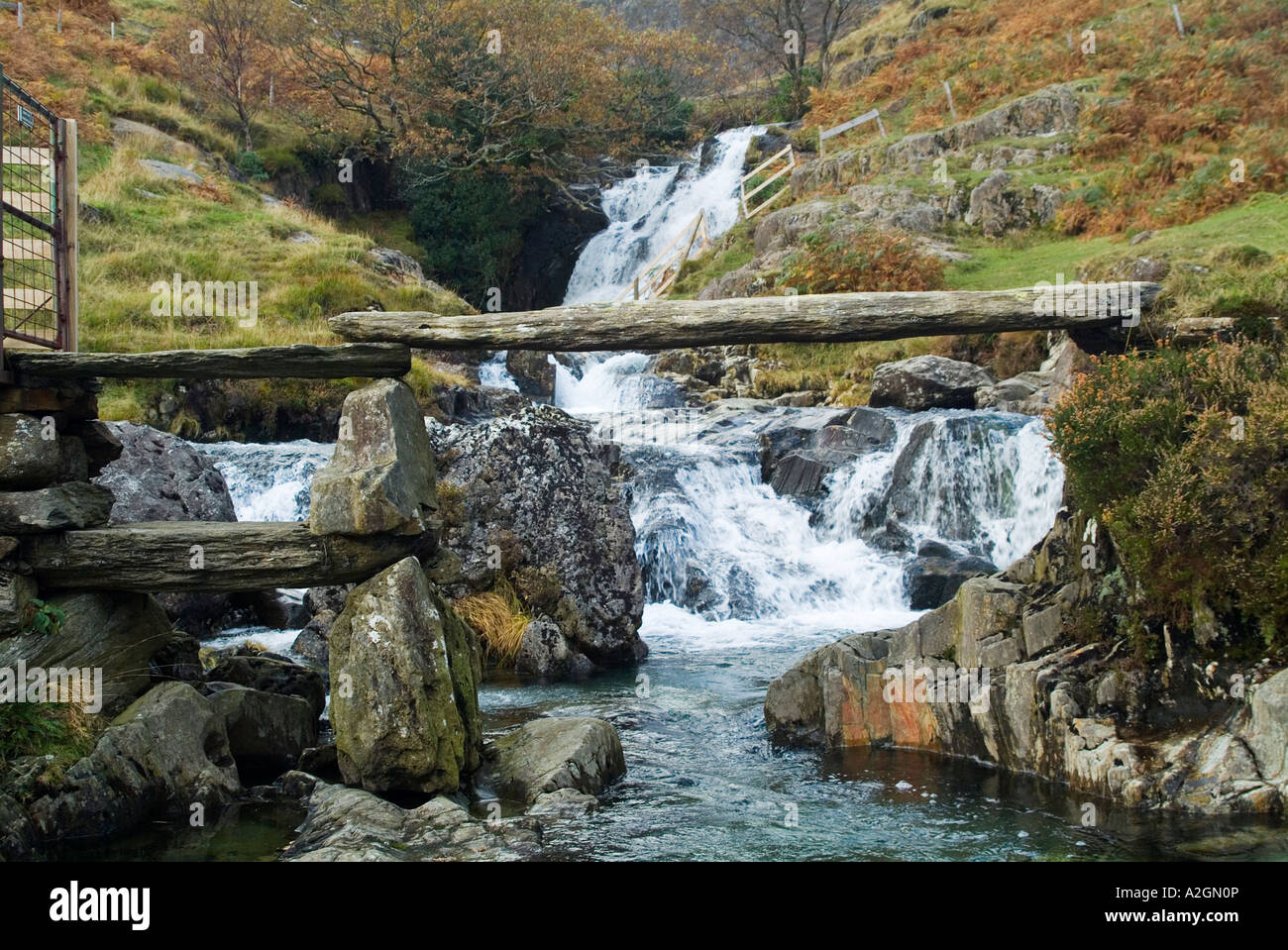 Miners stone bridge spanning Afon Llan which cascades down the slopes of Snowdon Stock Photo