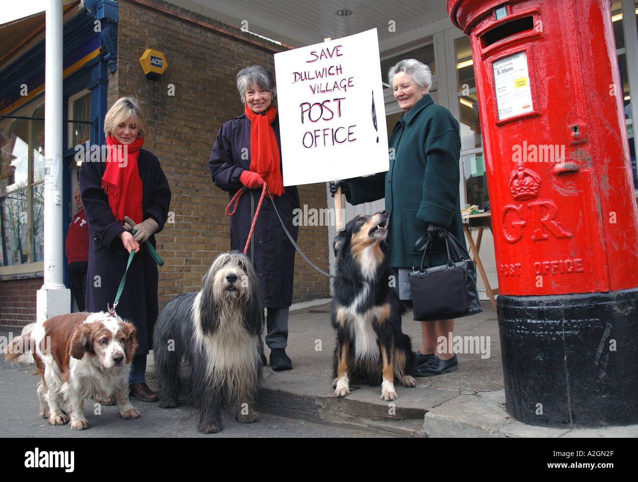 Local residents protesting in front of local post office attempting to save it from being sold. Stock Photo