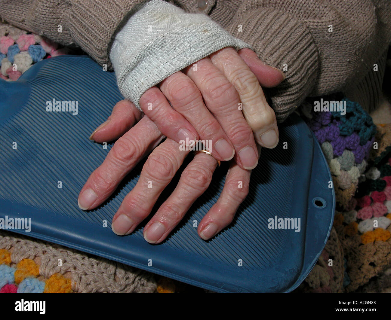elderly woman with copper support for arthritic wrist keeping warm with
