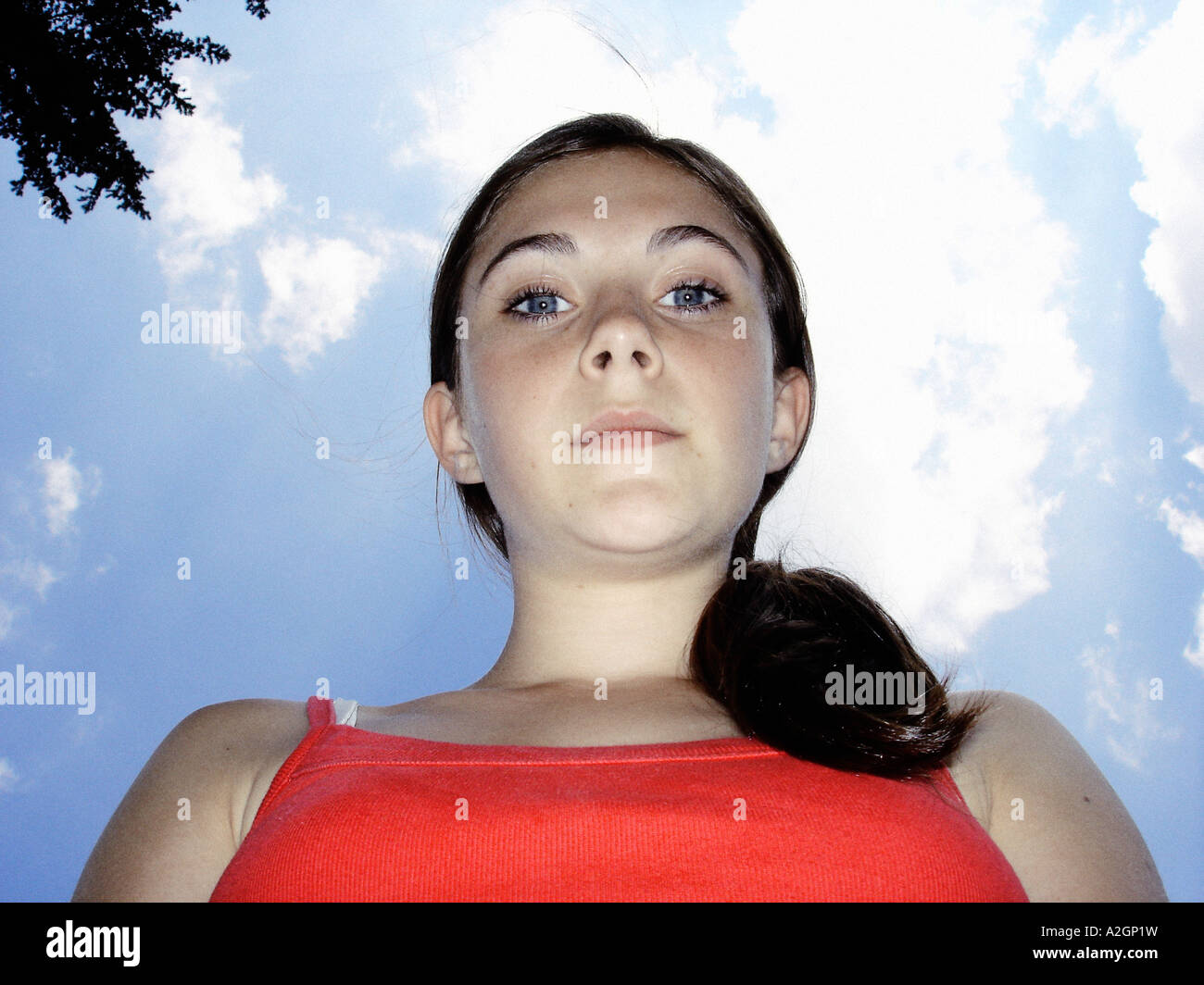 Portrait of a girl looking down onto a camera lens Stock Photo