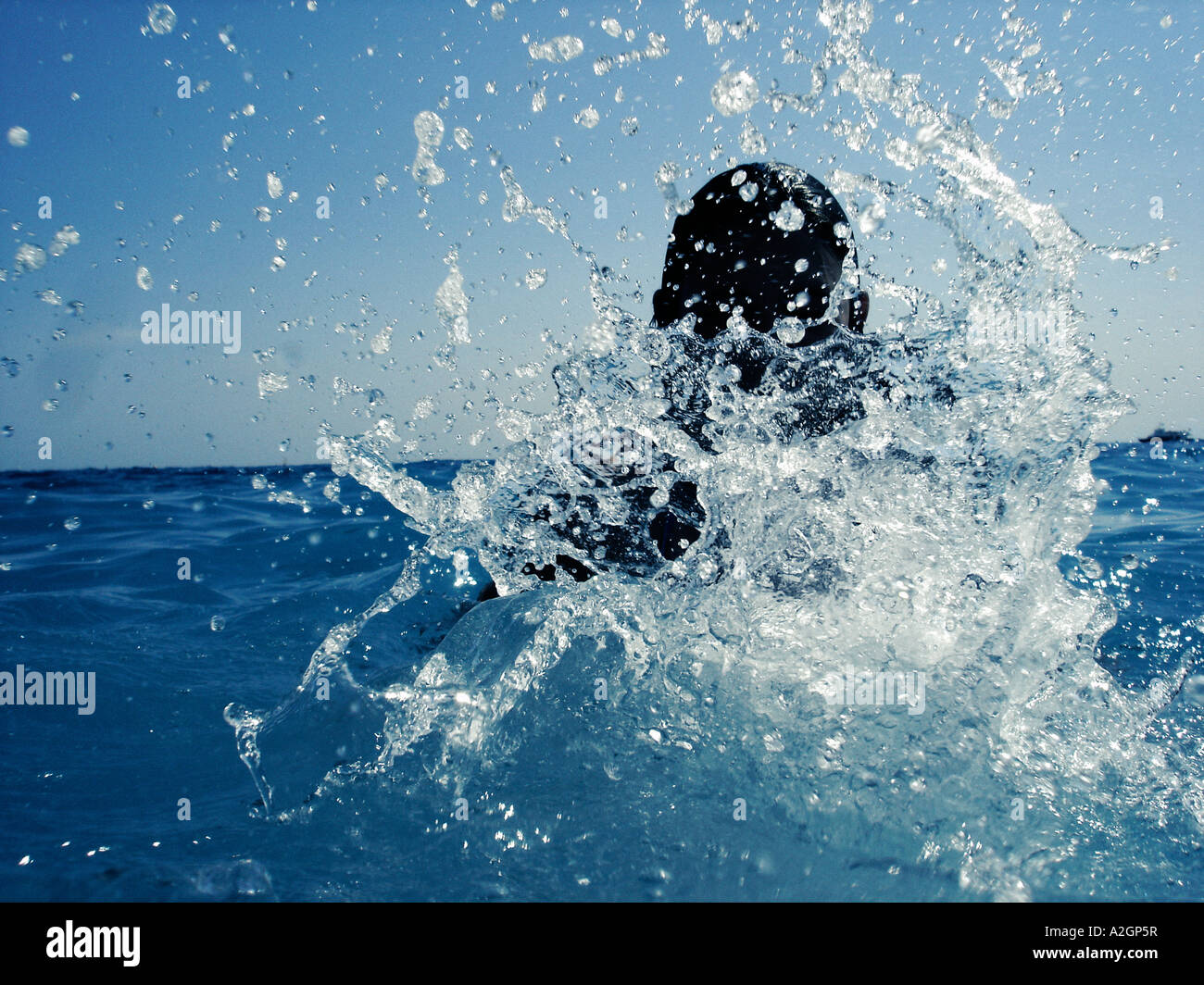 Man being splashed in the sea Stock Photo