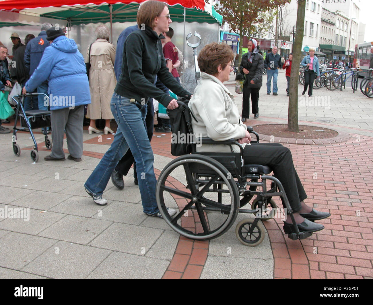 Woman in wheelchair pushed hi-res stock photography and images - Alamy