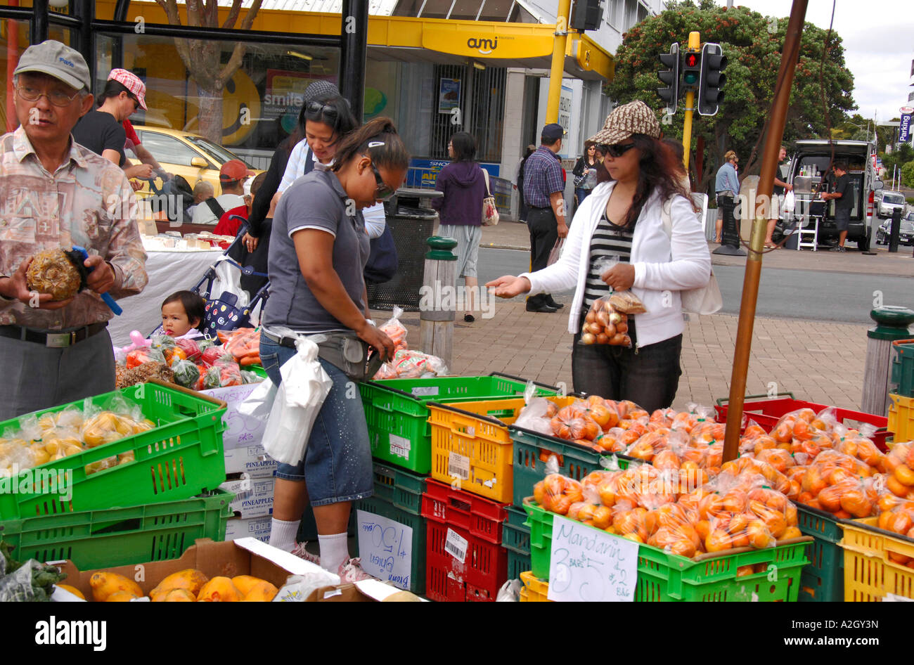 Customers buying oranges, Takapuna Sunday street market, North Shore