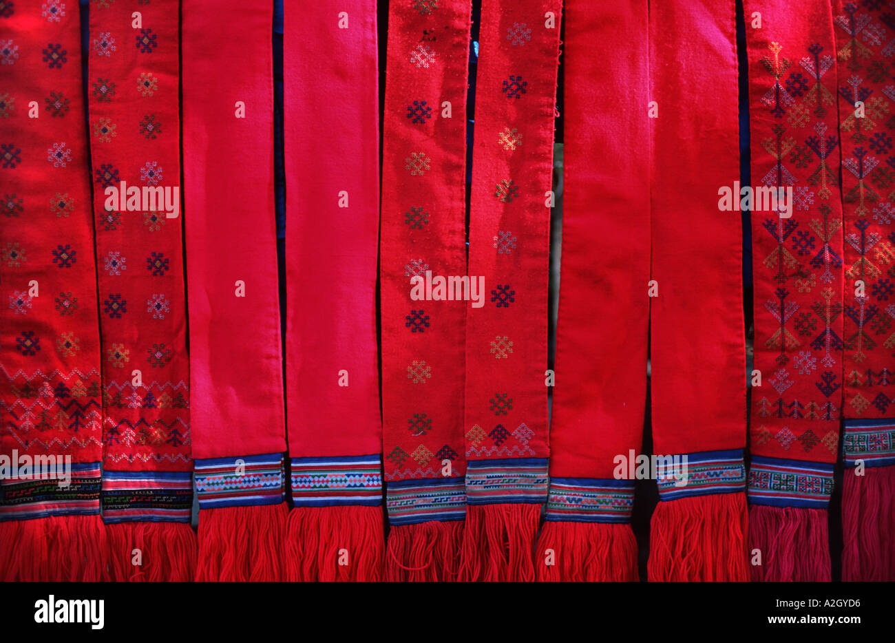 Selection of brightly coloured hip strap loom woven sashes at the Hmong market on Sisavangvong Luang Prabang Laos Stock Photo