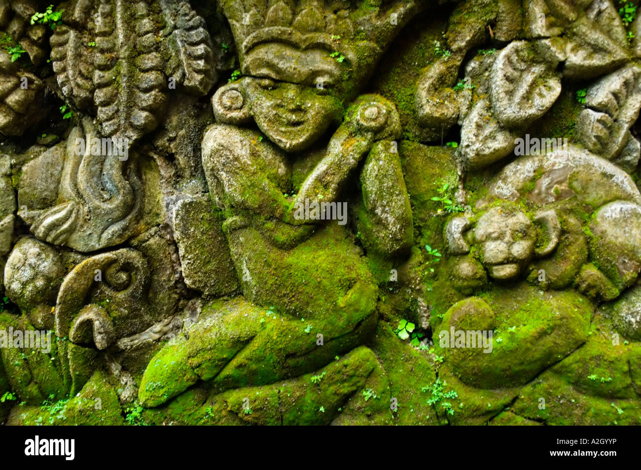 Indonesia Bali Ubud Agung Rai Museum of Art ARMA stone images covered by green moss and small plants Stock Photo