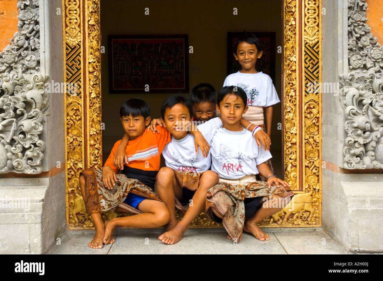 Indonesia Bali Ubud Agung Rai Museum of Art ARMA five boys posing in door frame of museum Stock Photo