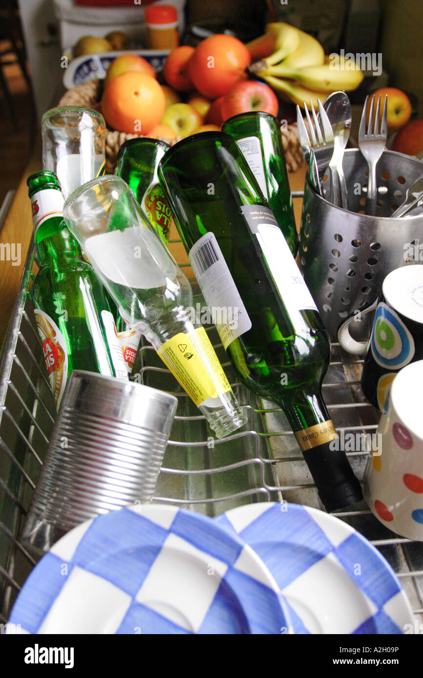 Recycling domestic waste washing up glass bottles and tins for