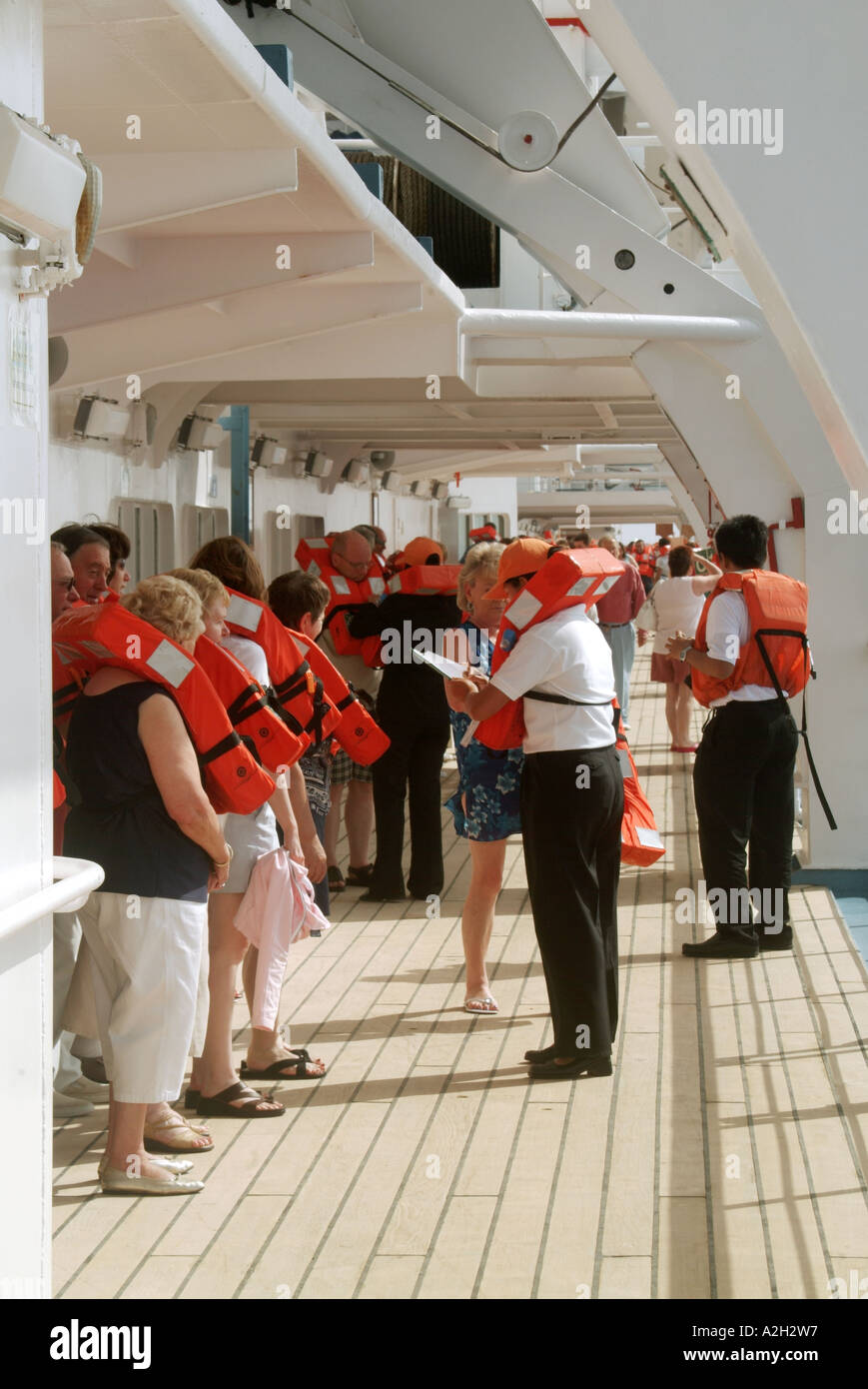 Mediterranean cruise ship passengers on board cruise liner at sea in compulsory practice of lifeboat evacuation procedures to abandon ship Stock Photo