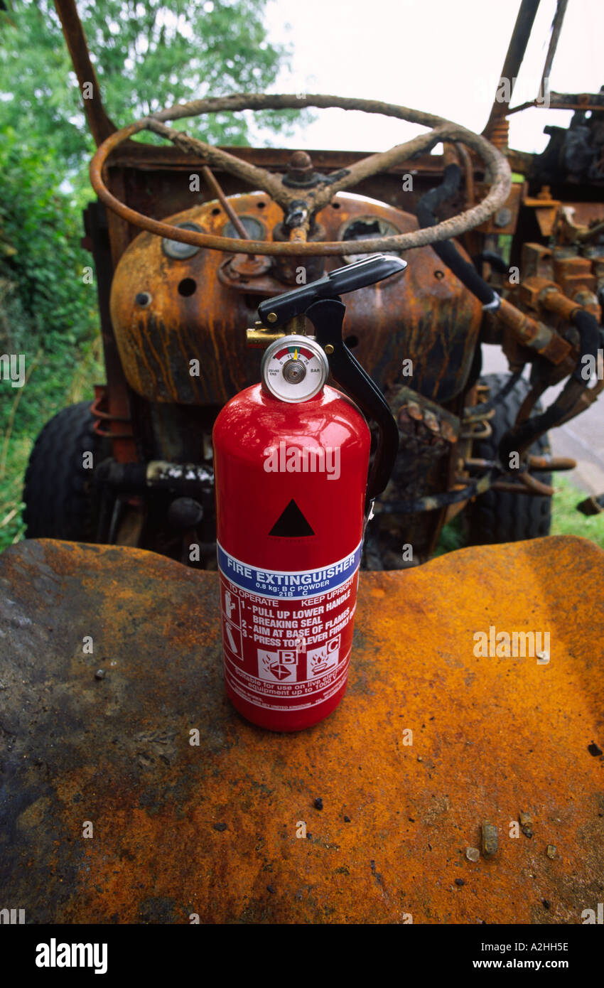 Fire extinguisher on the seat of a burnt out tractor in Dorset county