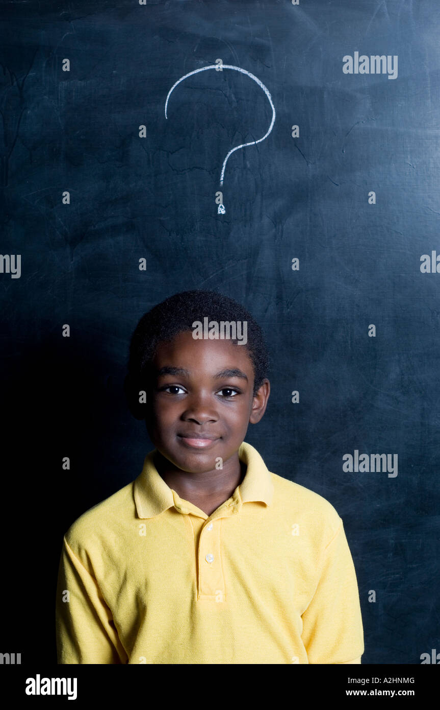 African American Student in a classroom with question mark on the blackboard Stock Photo