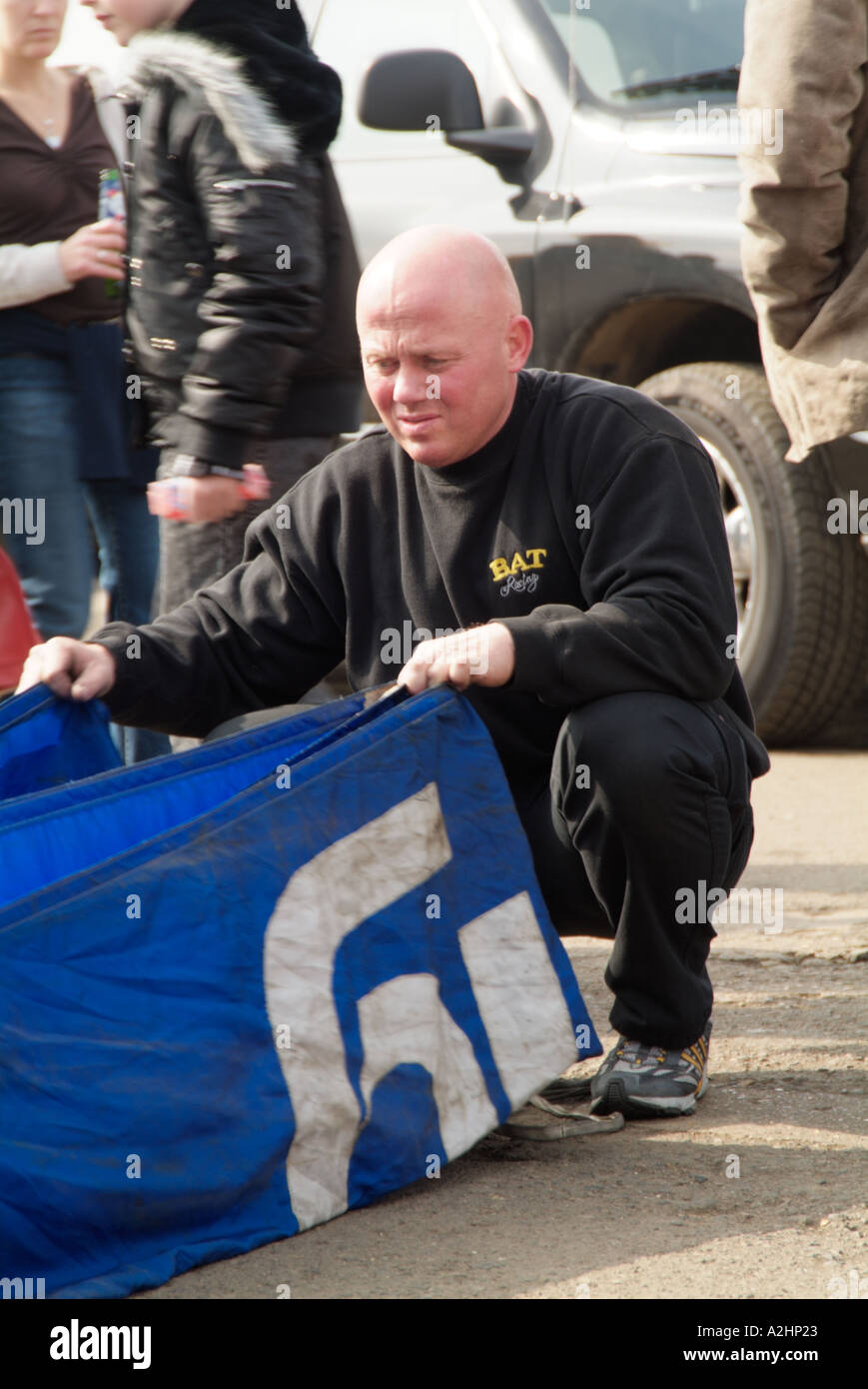 norweigen drag racer thomas natass packs the parachute packs on the back of a top fuel dragster used to slow the car down Stock Photo