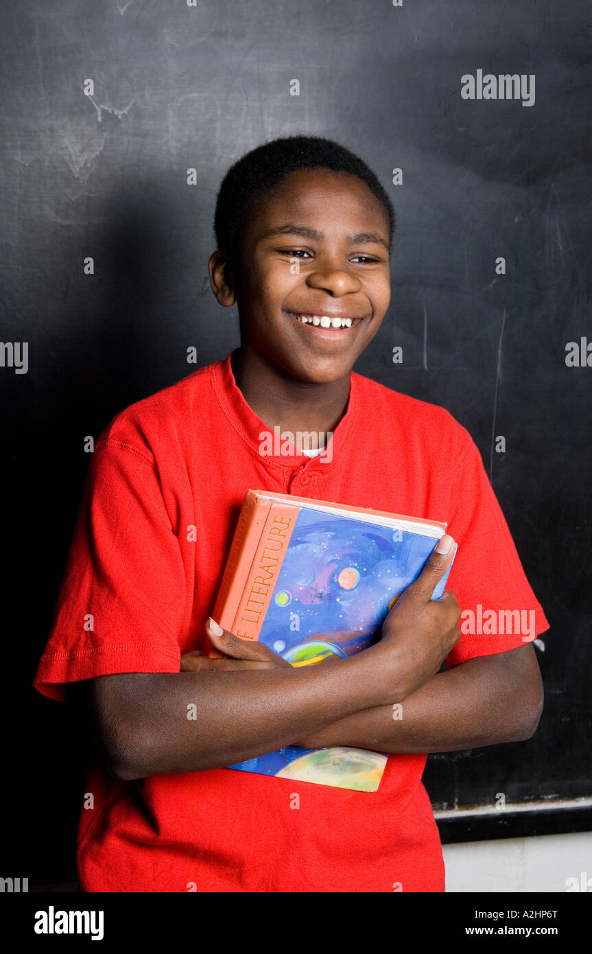 Student In Classroom laughing while holding a book Stock Photo - Alamy