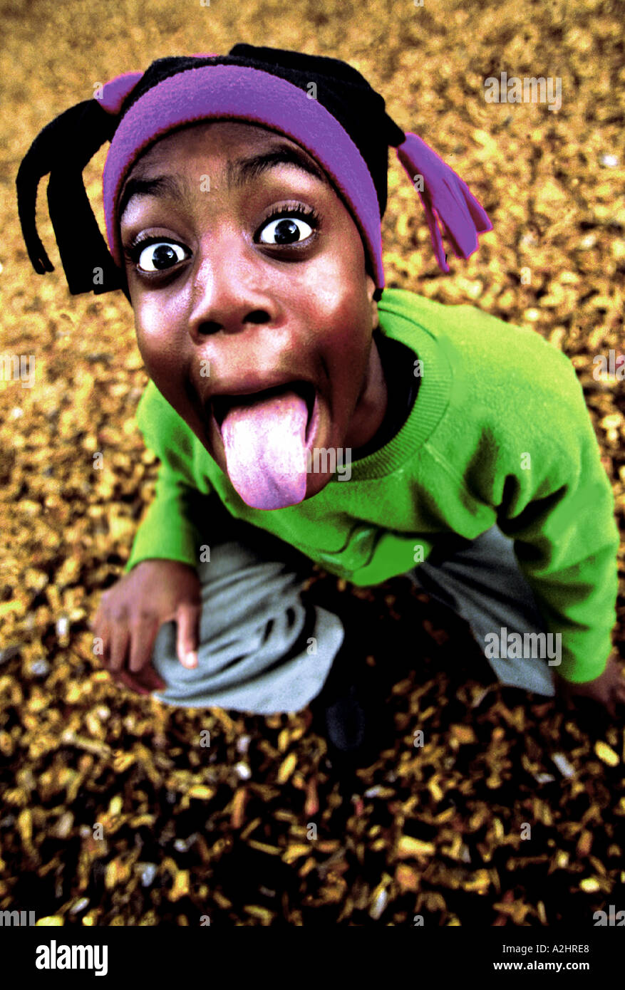 Negro boy age 8-10 pulling tongues into camera. The Image was shot from slightly above. Stock Photo
