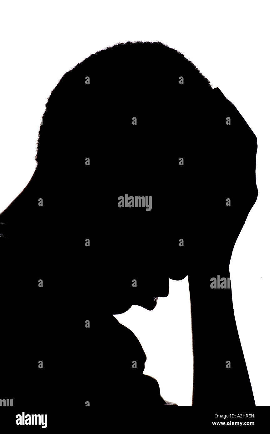 Silhouette of a young African American kid with hand on his head on a white background Stock Photo