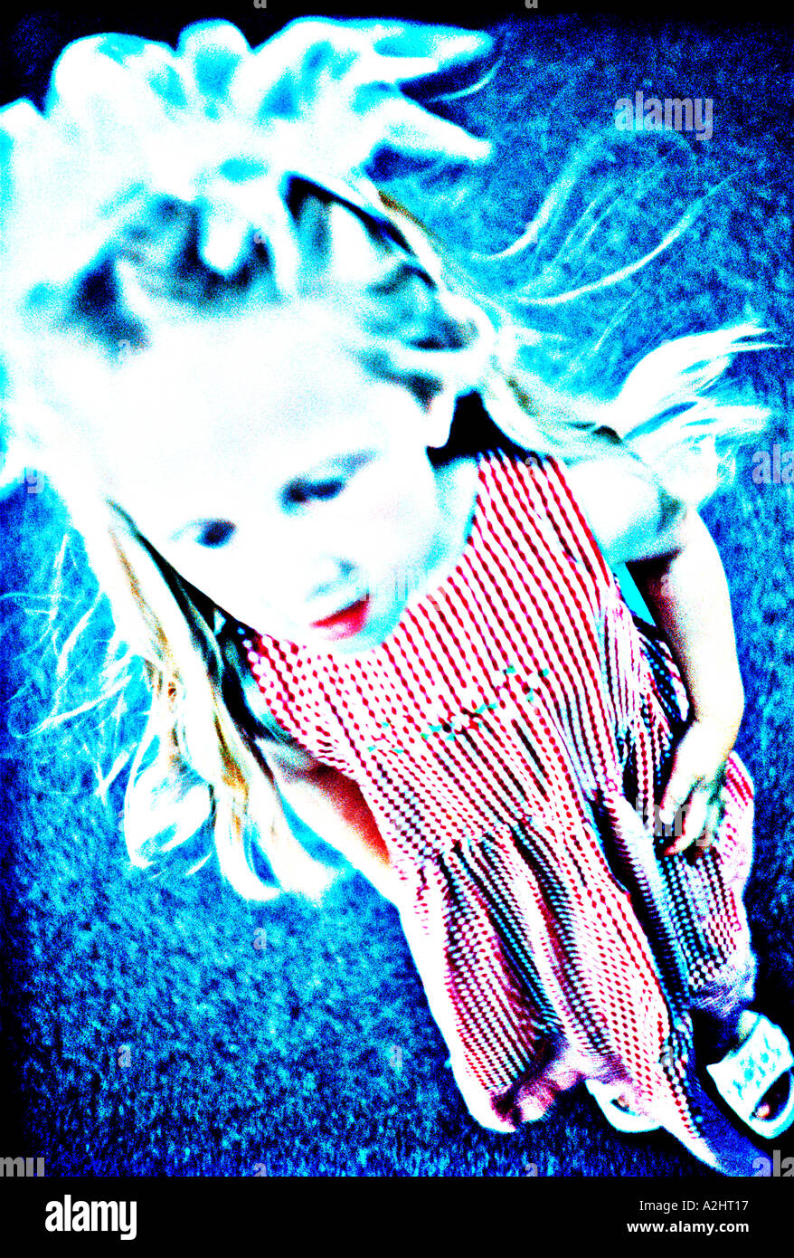 child age 5-7 shot from above and wearing a striking dress. Stock Photo